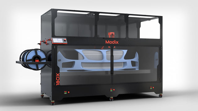 Modix BIG-180X large-format 3D printer with a full-size car bumper on the bed